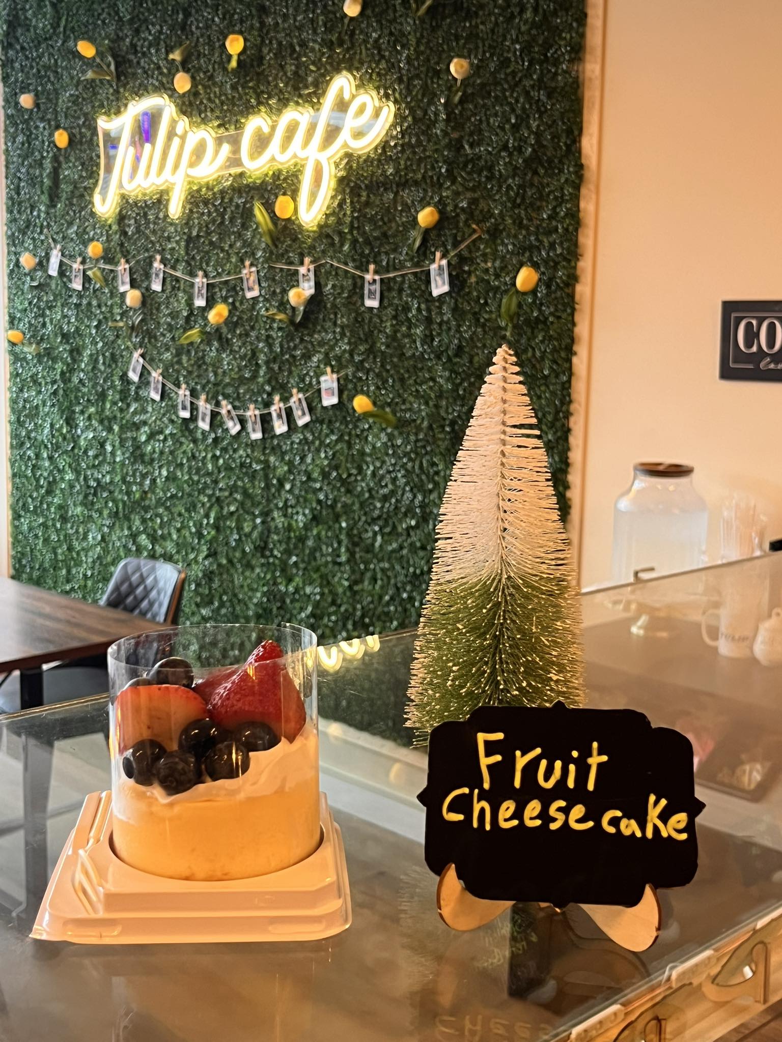 Tulip Cafe neon sign with fruit cheesecake